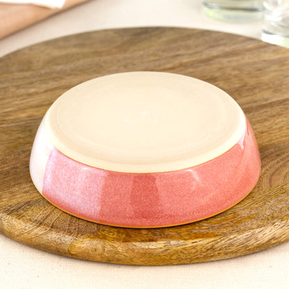 Base of a wheel-thrown tapas bowl in Coral & White, showing the smooth burnished foot and makers mark, handmade in a small Sussex pottery studio