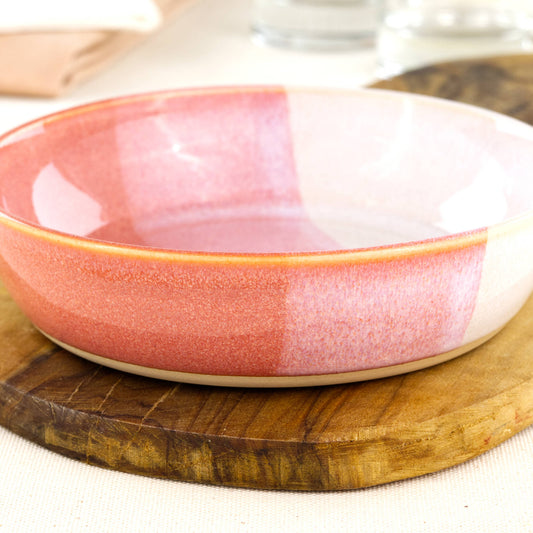 Close-up of a handmade stoneware tapas bowl in Coral & White, highlighting the glossy speckled glaze, warm peachy tones and shallow shape for dips, olives and antipasti