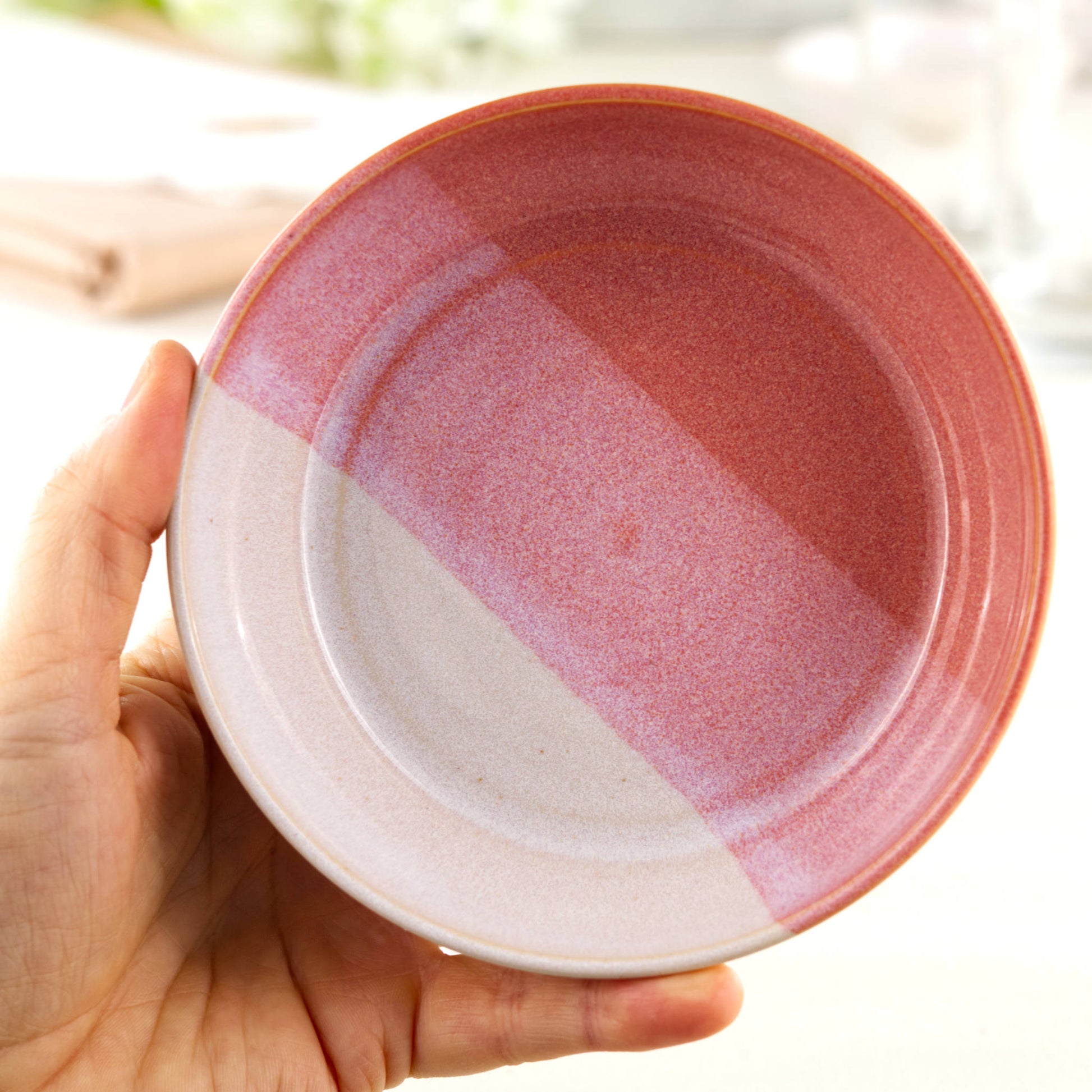 Handmade ceramic tapas bowl held in the hand, finished in Coral & White glazes with a flatter interior designed for mezze, small plates, side dishes and sharing food
