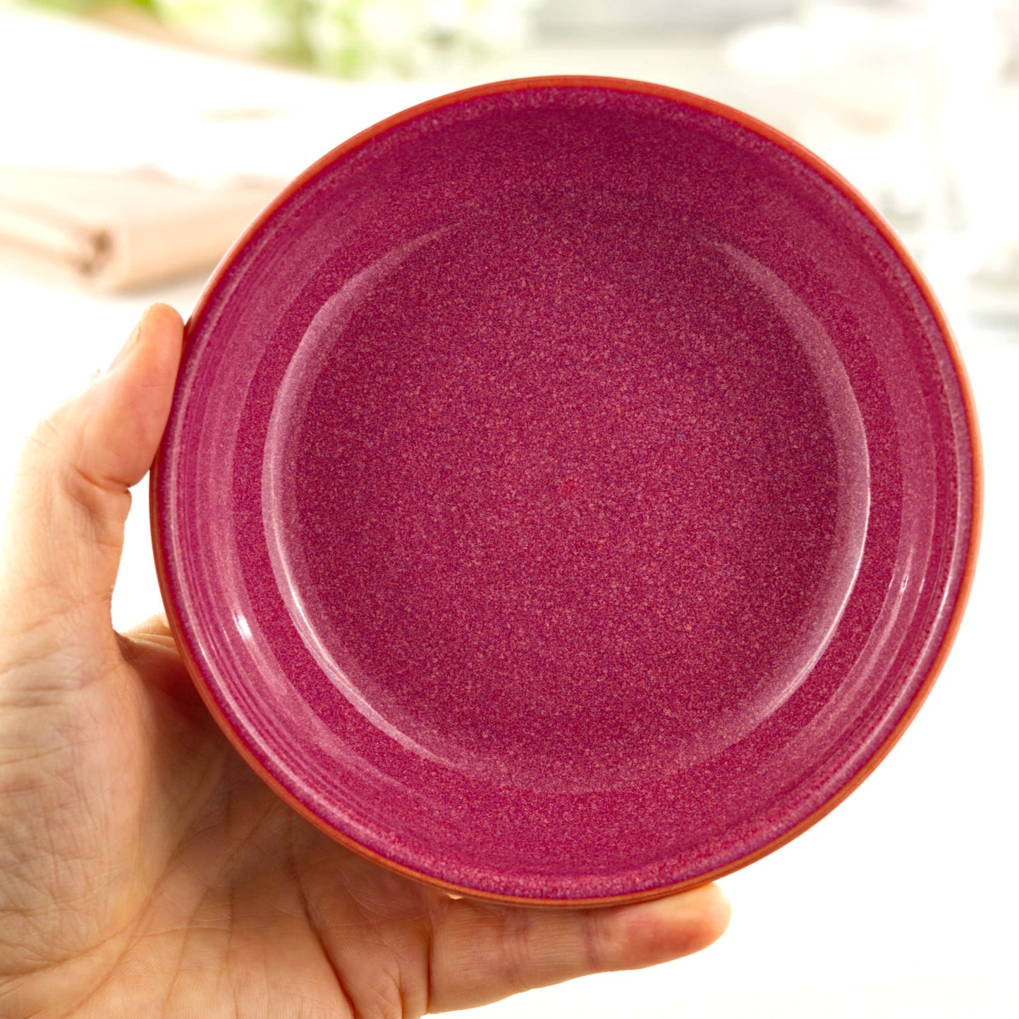 Handmade Crimson ceramic tapas bowl held in the hand, a piece of British studio pottery sized for olives, dips, mezze and everyday nibble bowls