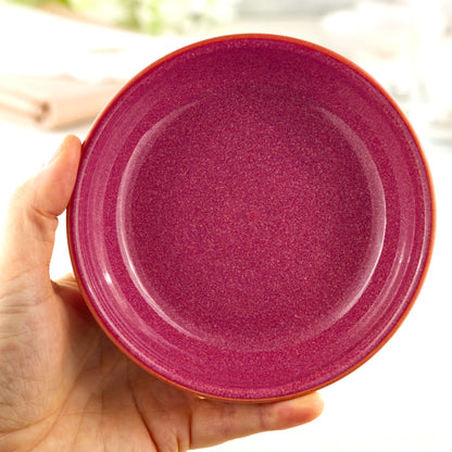 Handmade Crimson ceramic tapas bowl held in the hand, a piece of British studio pottery sized for olives, dips, mezze and everyday nibble bowls