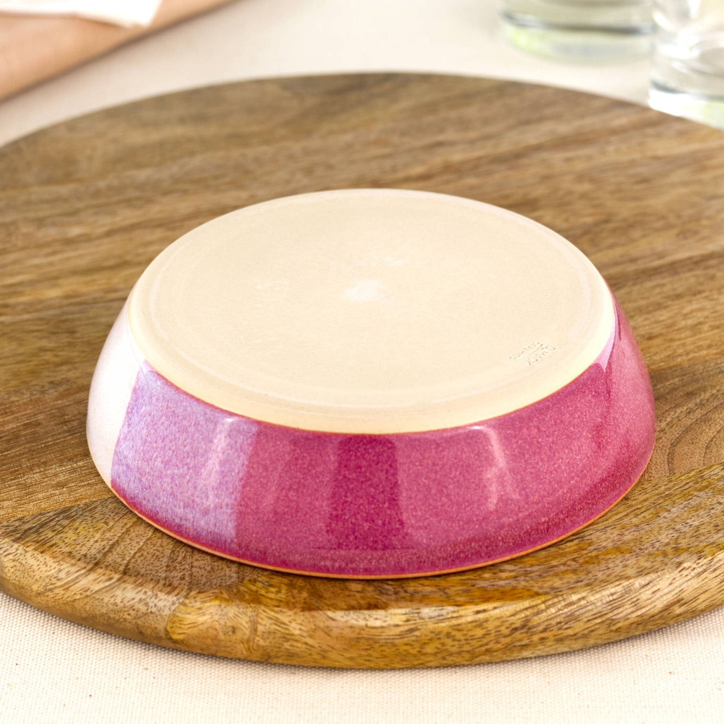 Base of a wheel-thrown tapas bowl in Crimson & White, showing the smooth burnished foot and makers mark, handmade in a small Sussex pottery studio