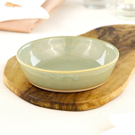 Wheel-thrown Pale Green tapas bowl on an olive wood board, handcrafted in Sussex for antipasti, picky bits, BBQ nibbles and artisan tableware