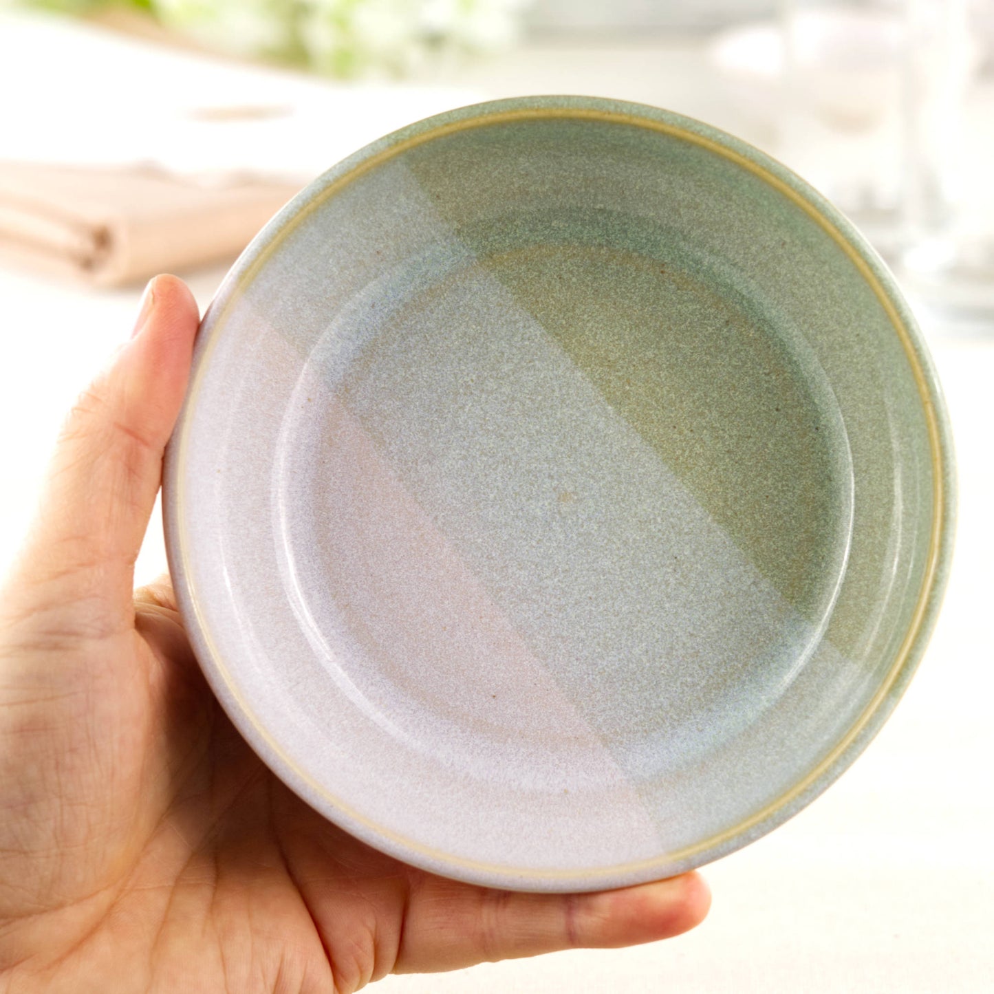 Handmade ceramic tapas bowl held in the hand, finished in Pale Green & White glazes and sized for mezze, nibbles, side dishes and casual sharing food